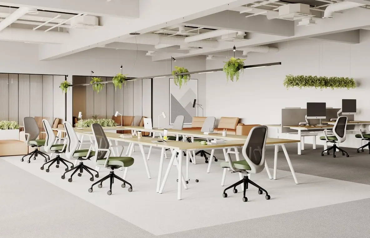 Long communal oak desk with white A-frame legs and green-seat mesh chairs under hanging planters