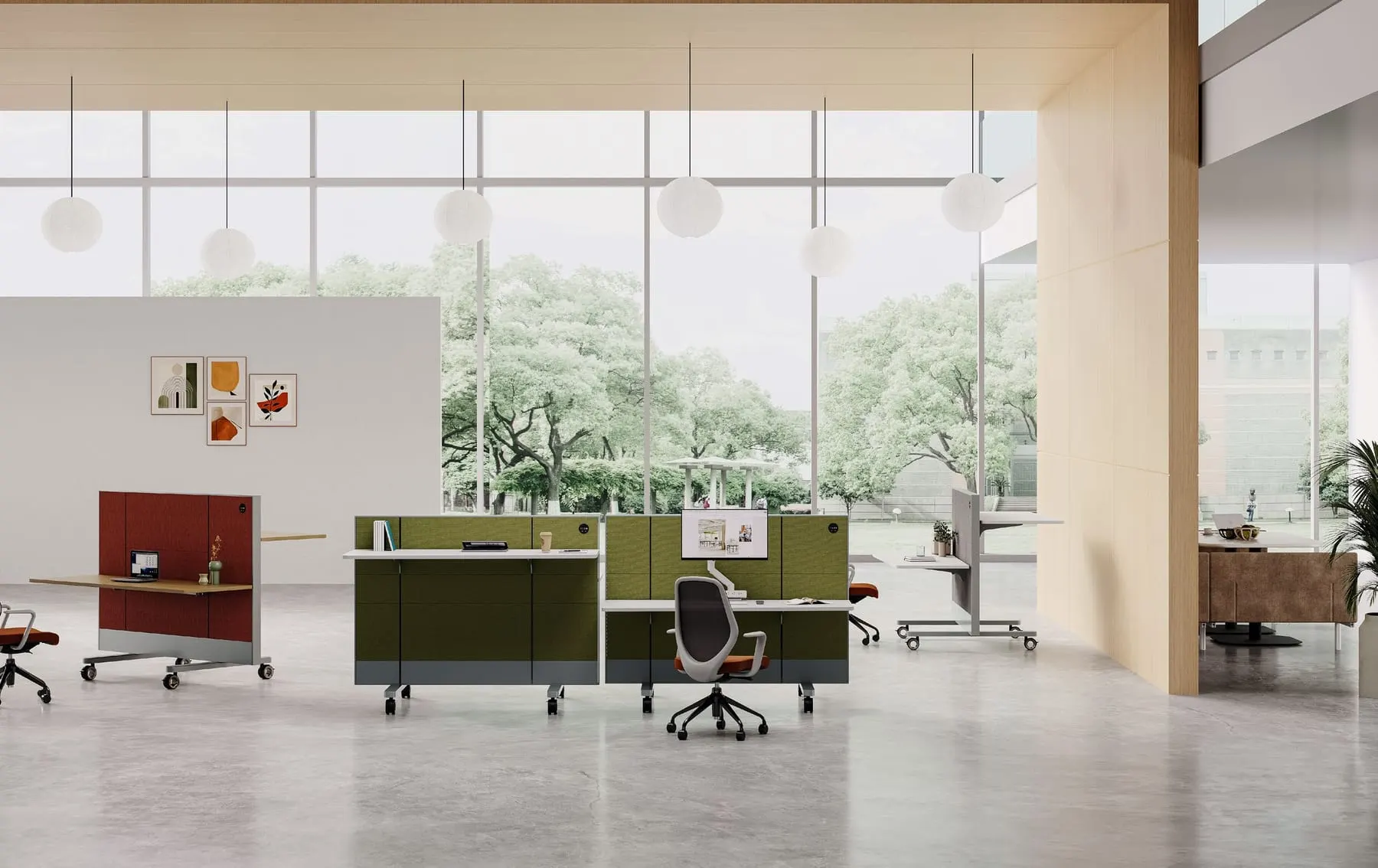 Mobile height-adjustable panel workstations with red and olive acoustic panels on casters in a bright open office