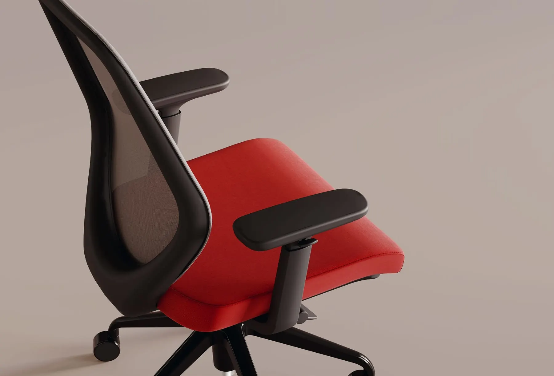 Close-up of an ergonomic task chair with black mesh back, red seat and adjustable black armrests