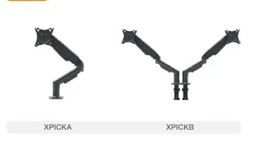 Dark grey articulating monitor arm with VESA plate clamped to an oak sit-stand desk beside keyboard