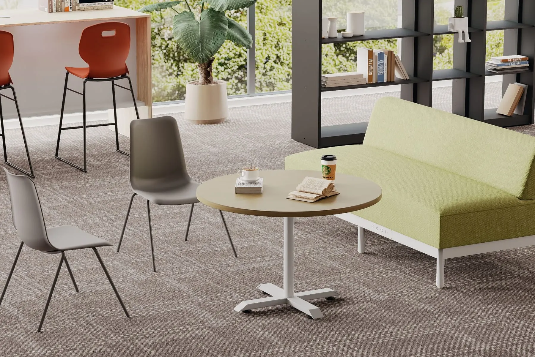 Round oak-top table on a white four-star base beside a lime-green sofa and grey shell chairs