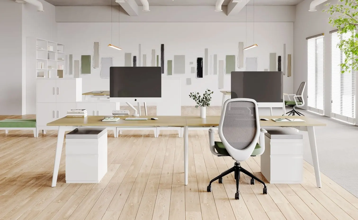 Oak-top double benching desk with white tapered legs, monitors, white pedestals and mesh chairs in a bright office